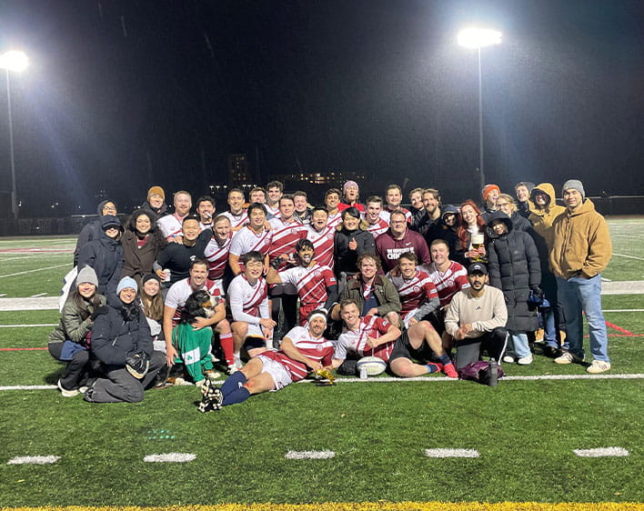 Christos Papandreou and sports team on field at night 