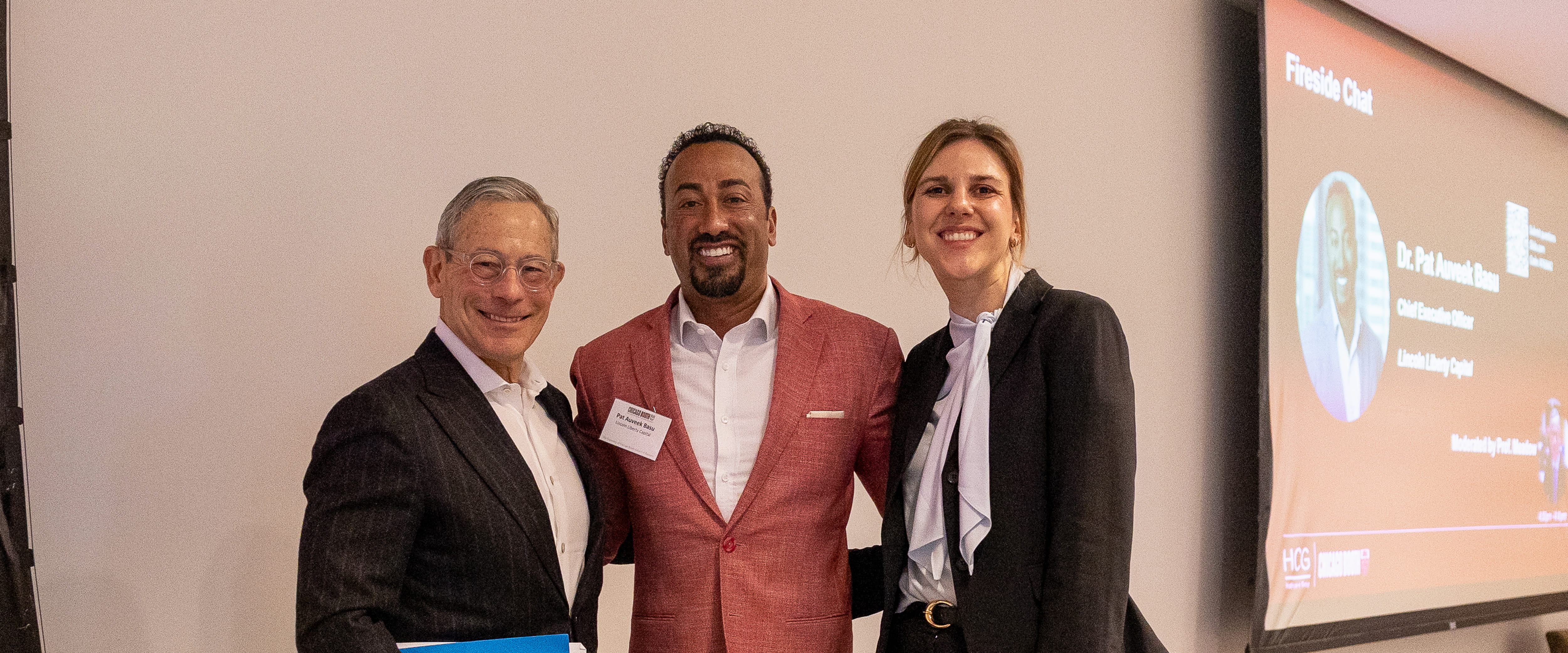 Speakers smiling posing for a photo