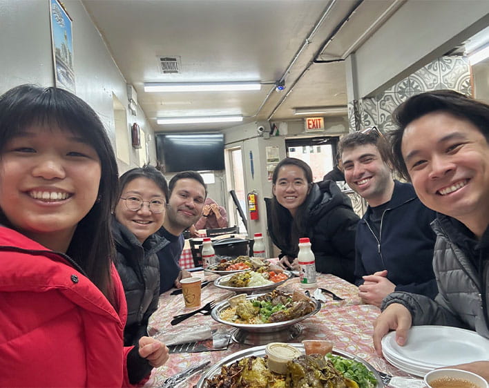 selfie of Jenett Cheng and friends smiling at restaurant 