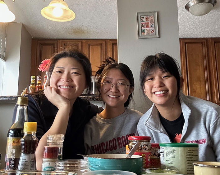 Jenett Cheng with friends at table smiling