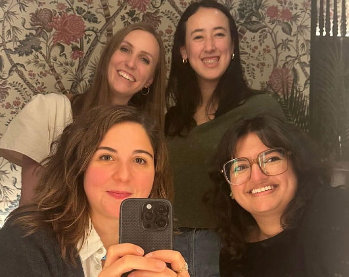 Nehir and three friends smiling in mirror picture