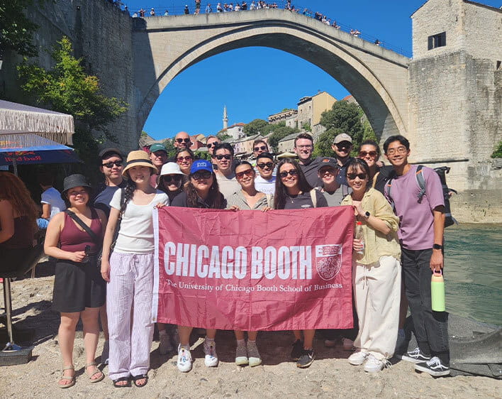 Students holding booth flag