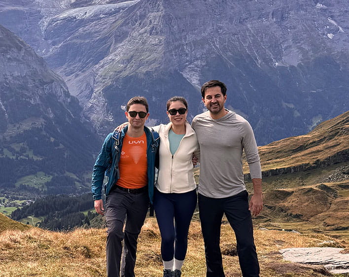 Sharan Chawla with two friends smiling in mountains 