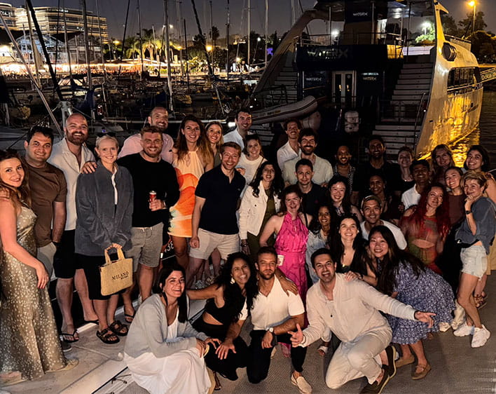 Sharan Chawla with large group of 20+ people in group photo on boat