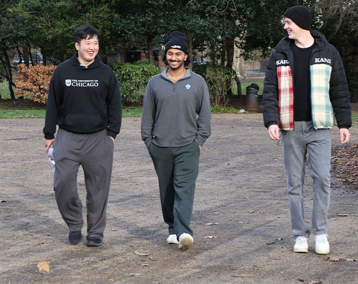 Stephen Kallubhavi walking and talking with two other Boothies outside