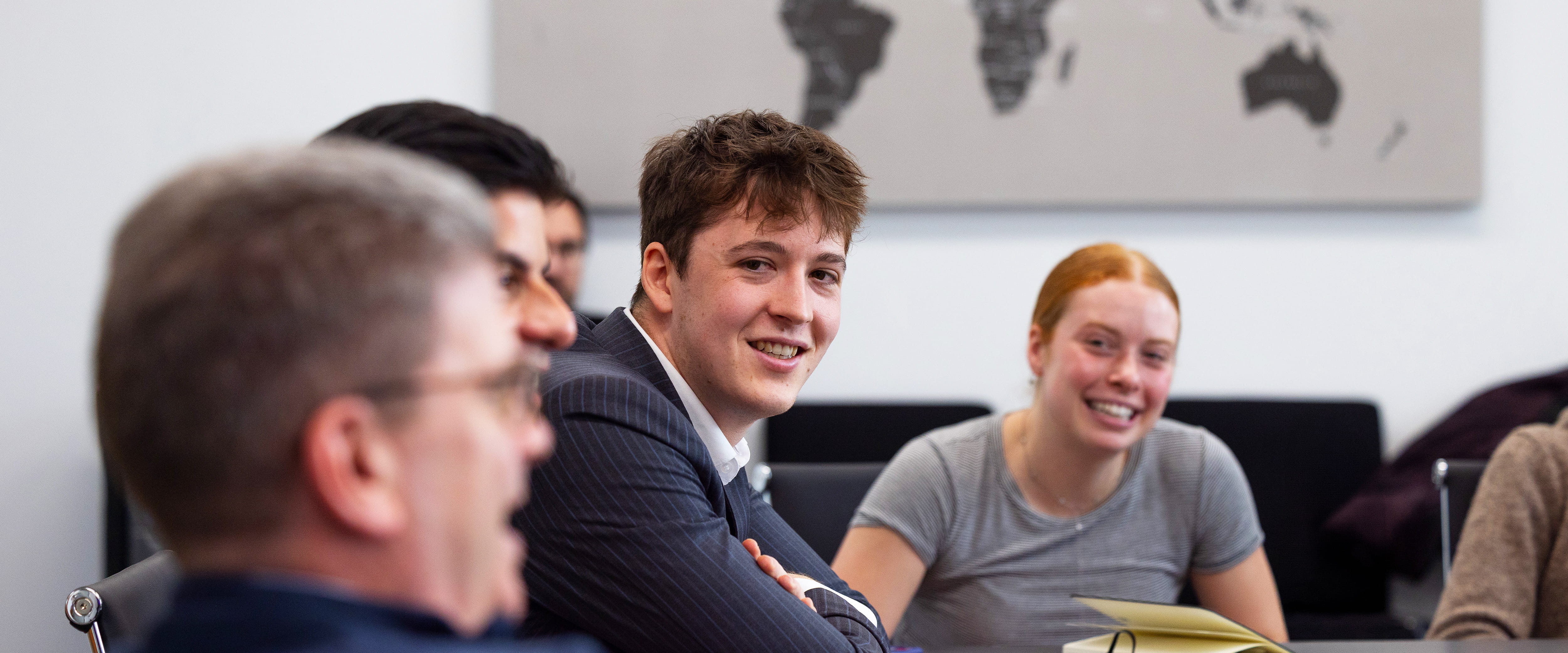 SMP student, Louis, smiling and listening.