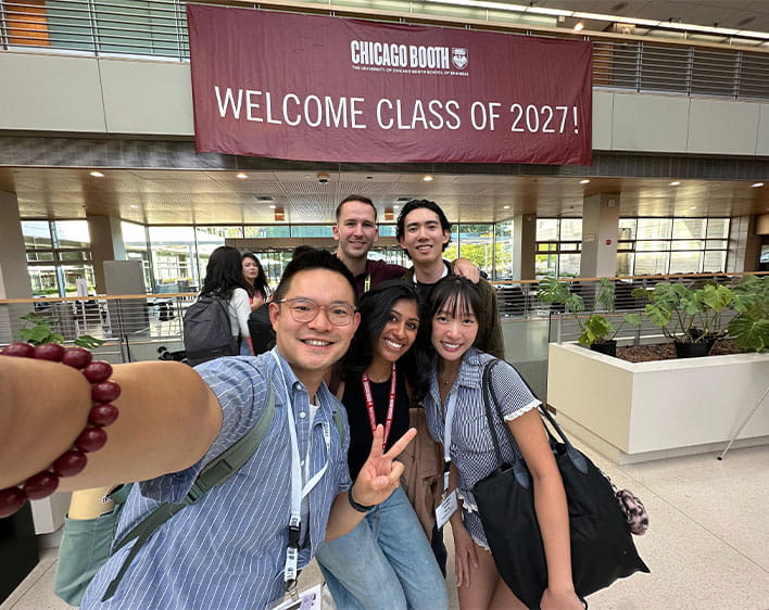 Trisha Atluri in selfie with Boothies in front of Welcome Class of 2027 sign