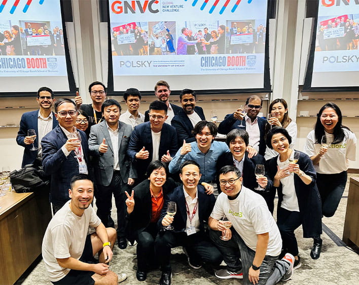 Yutaro Okamoto with group of 10+ Boothies in classroom with GNVC signage on projector