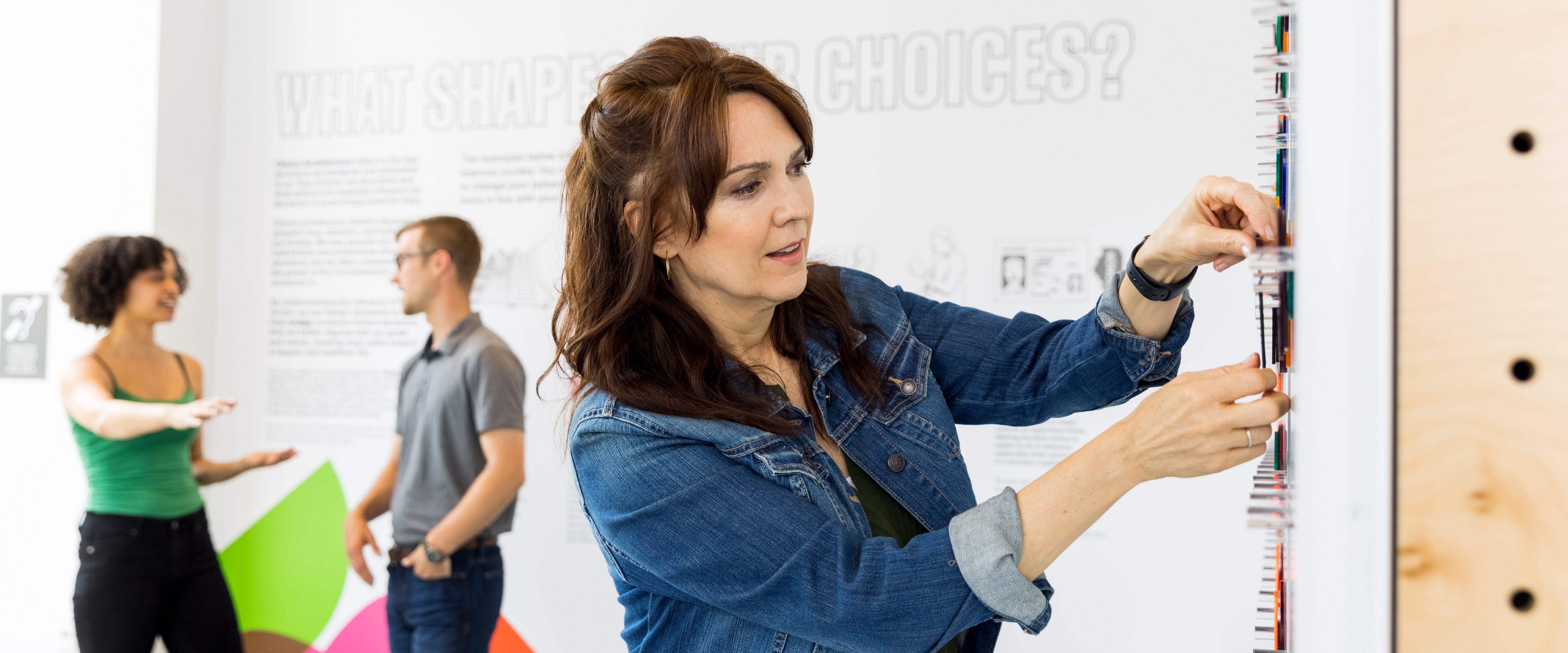 A woman engages with an exhibit at Mindworks.