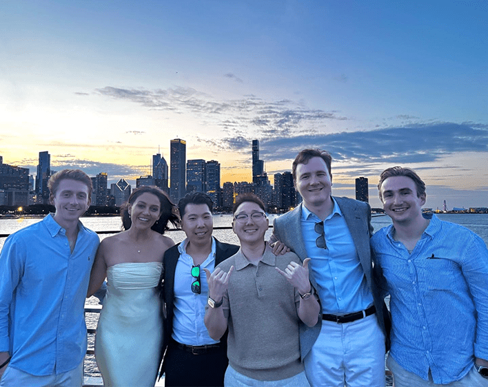 David Kim and boothies on boat smiling