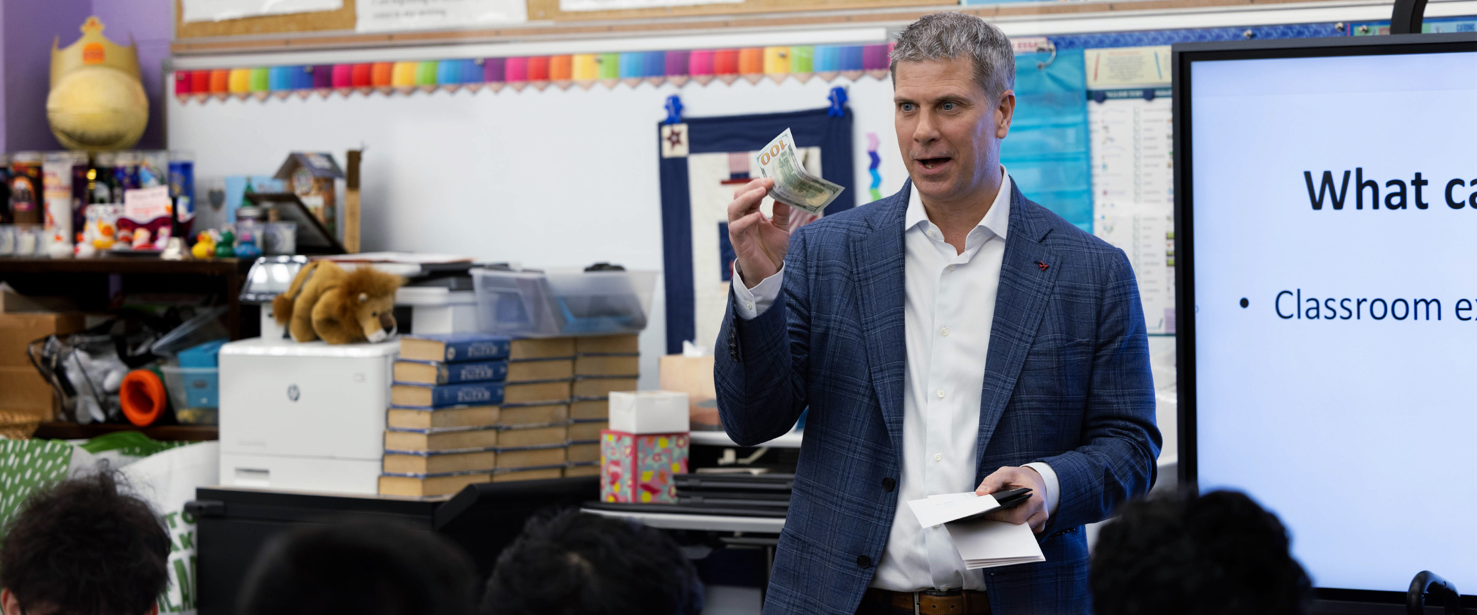 Jim Hoeg teaching students about money and the stock market 