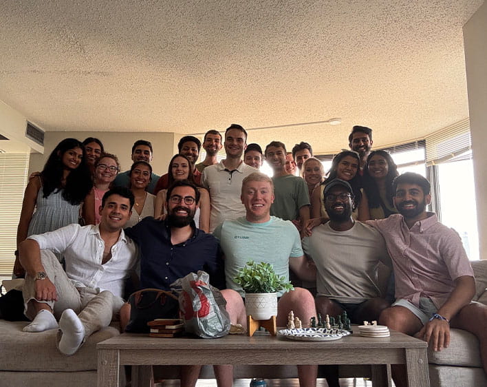 Tanvi Gopalabhatla and friends in group photo with some people sitting on couch