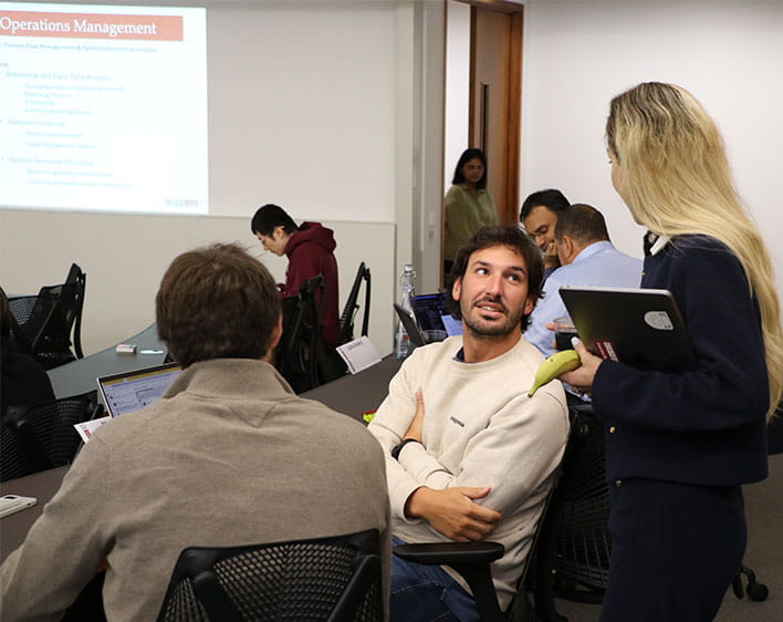 Tharwat El Zahran in classroom talking to peer