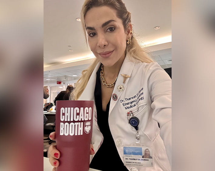 Tharwat El Zahran in work gown holding up Booth cup