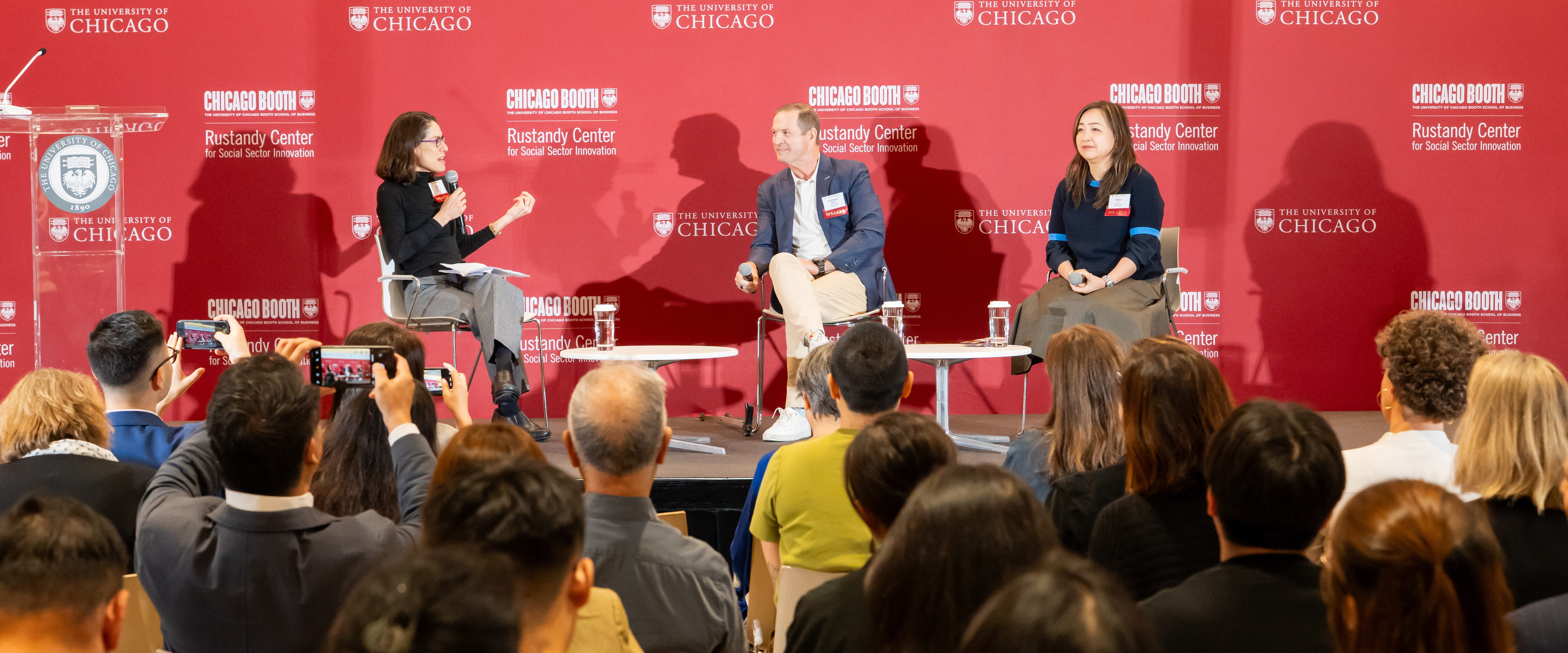 Candid shot of all three speakers on stage