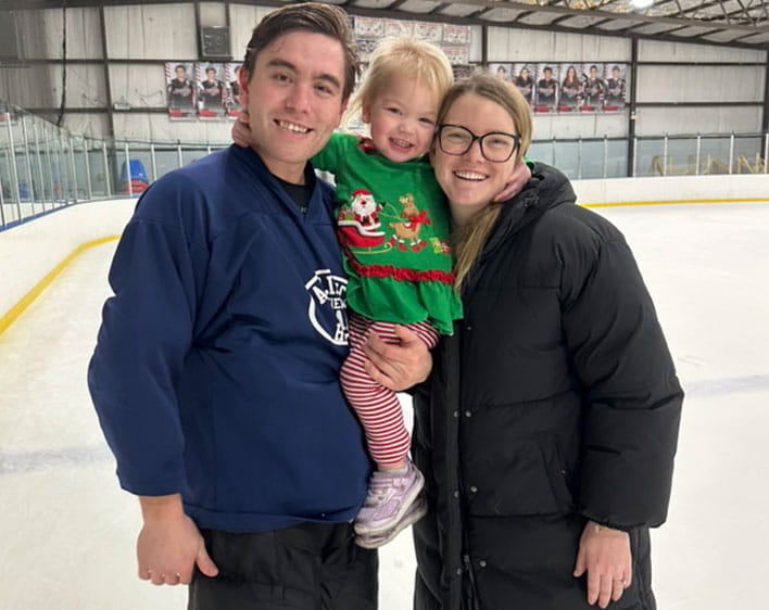 Madison with her daughter and husband on hockey ice