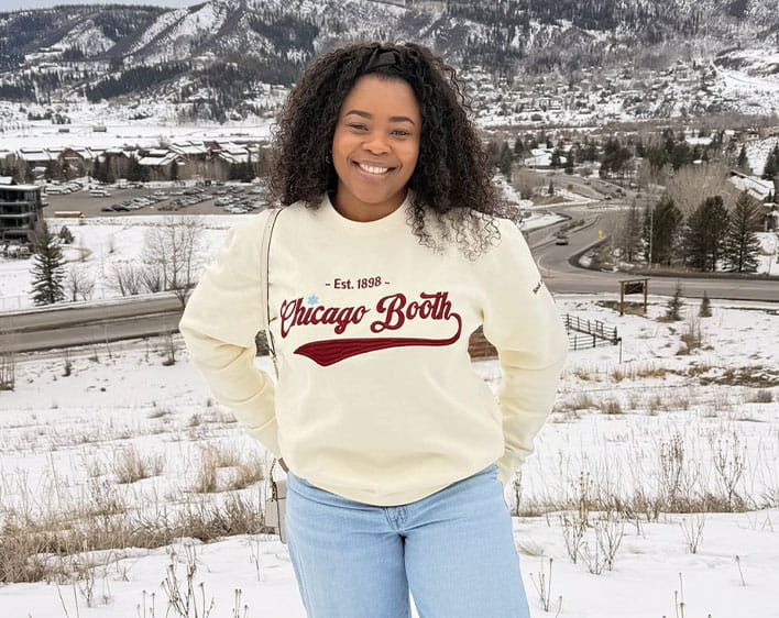Ude Adekunle at Black Ski Trip outing in Chicago Booth sweatshirt outside with snow in background