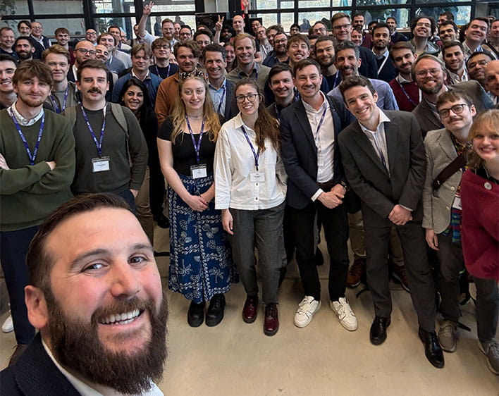 selfie of Zachary Hynek with group of people behind him at conference