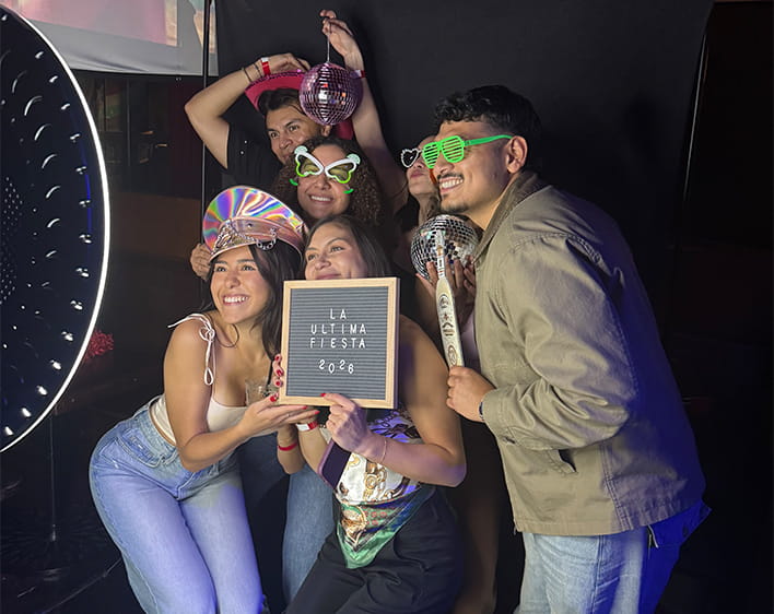 Camila Parra Ochoa and friends taking pictures at photo booth for La Ultima Fiesta event