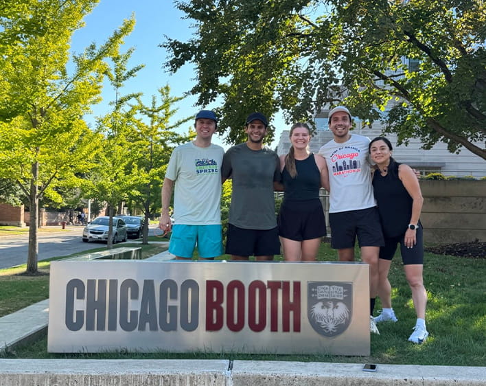Ricardo Haneine Tame and friends in front of Chicago Booth sign