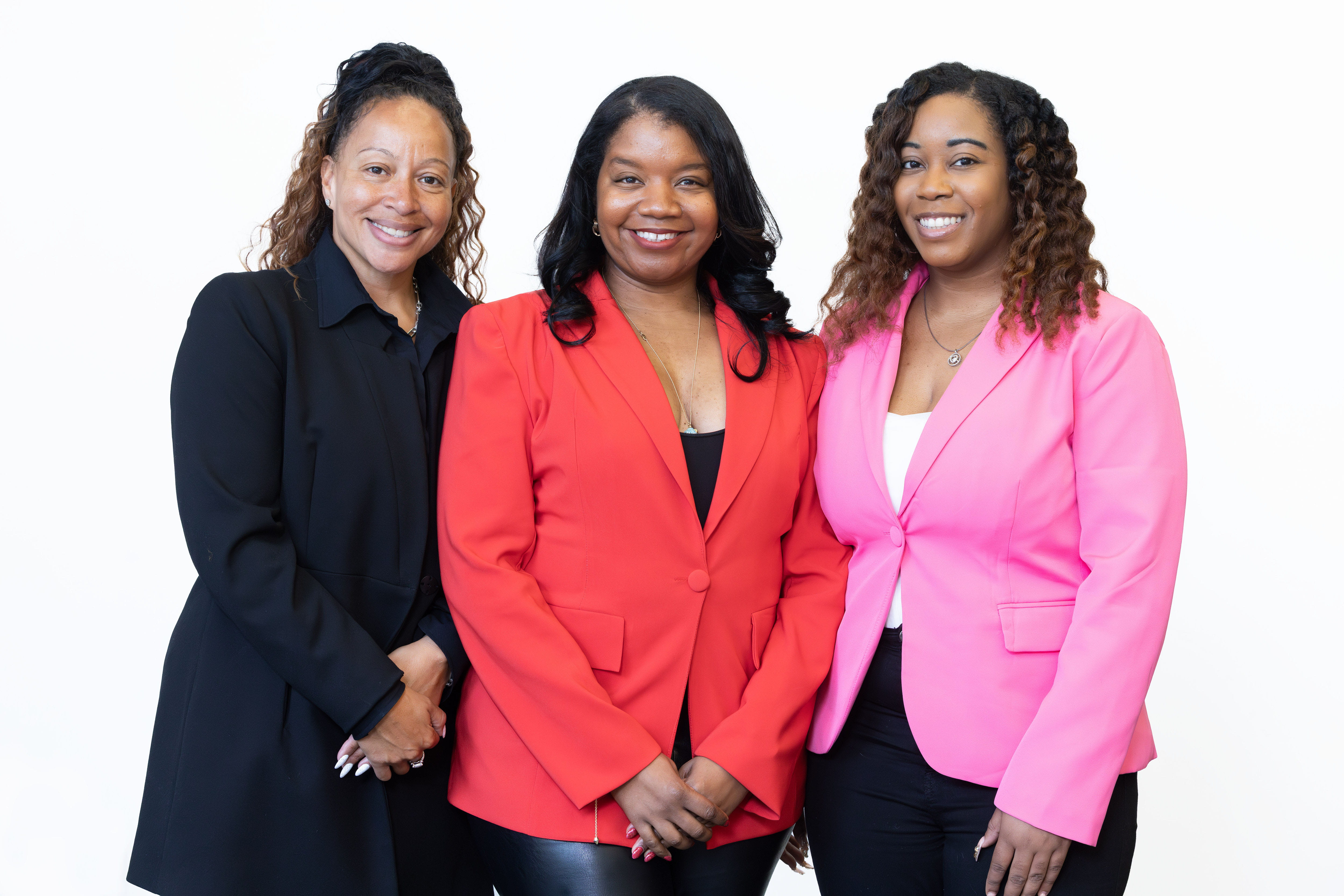 Three women standing together for a picture.