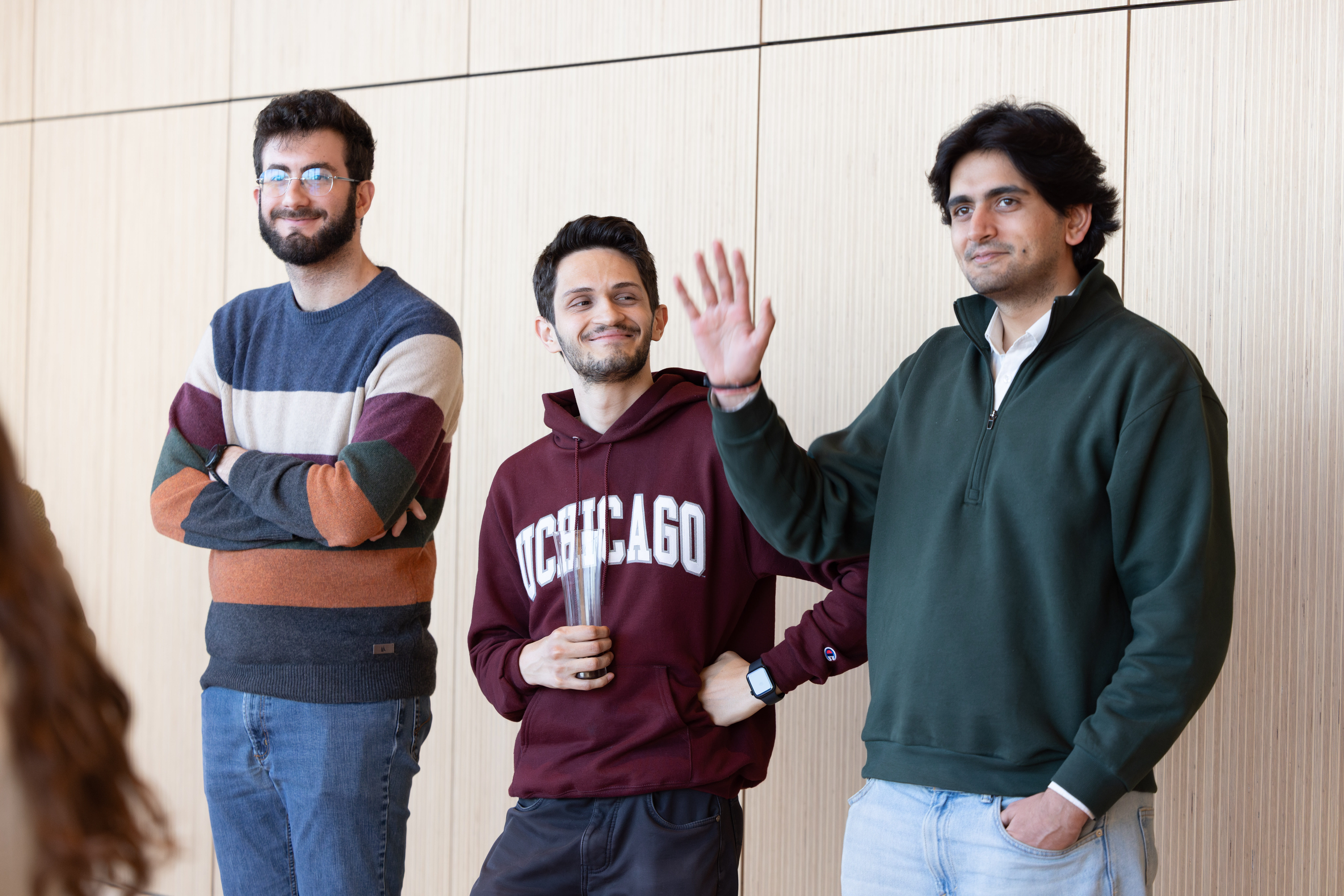 Stigler Center Research Professionals wave at a Booth event