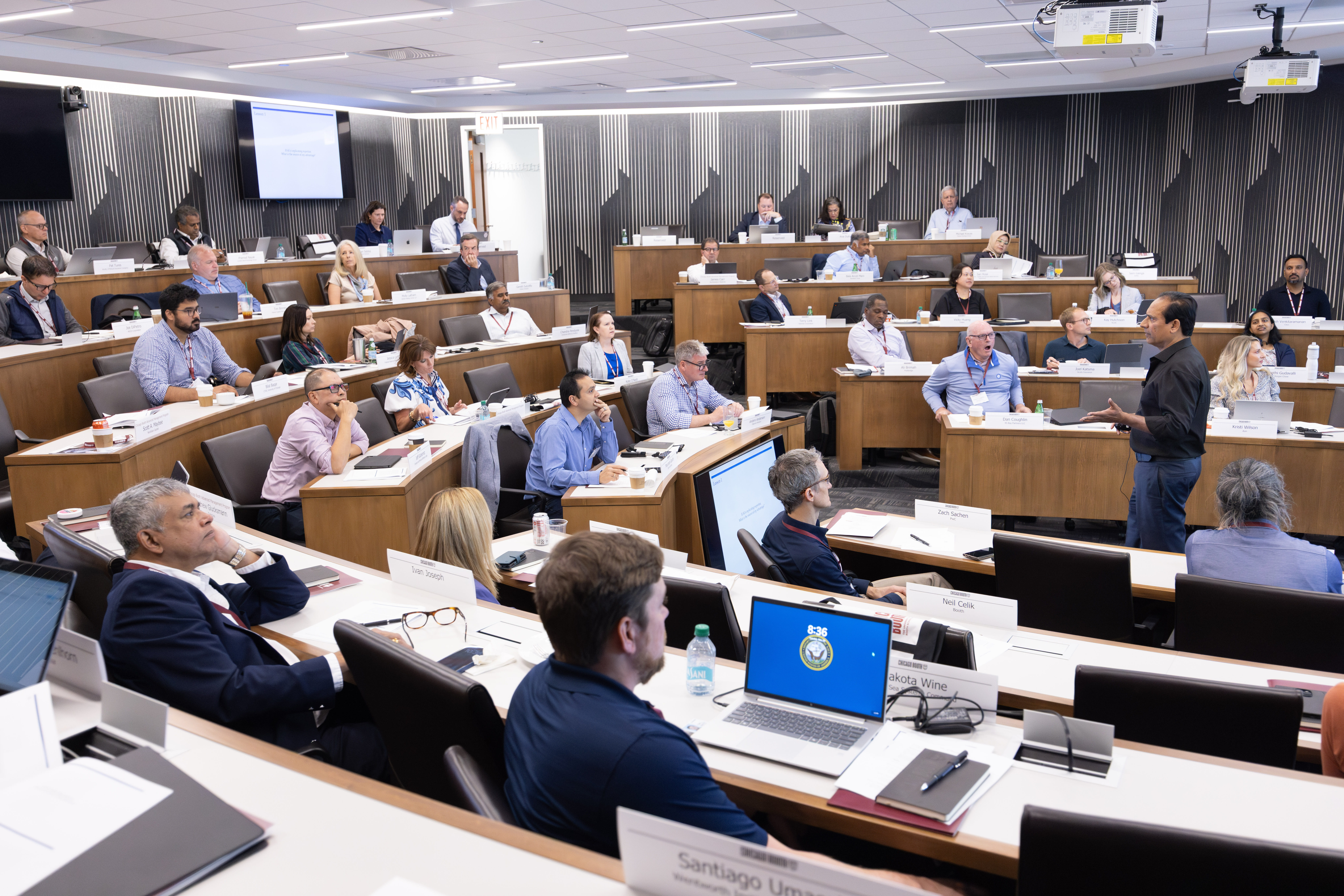 A group of participants are sitting in a classroom