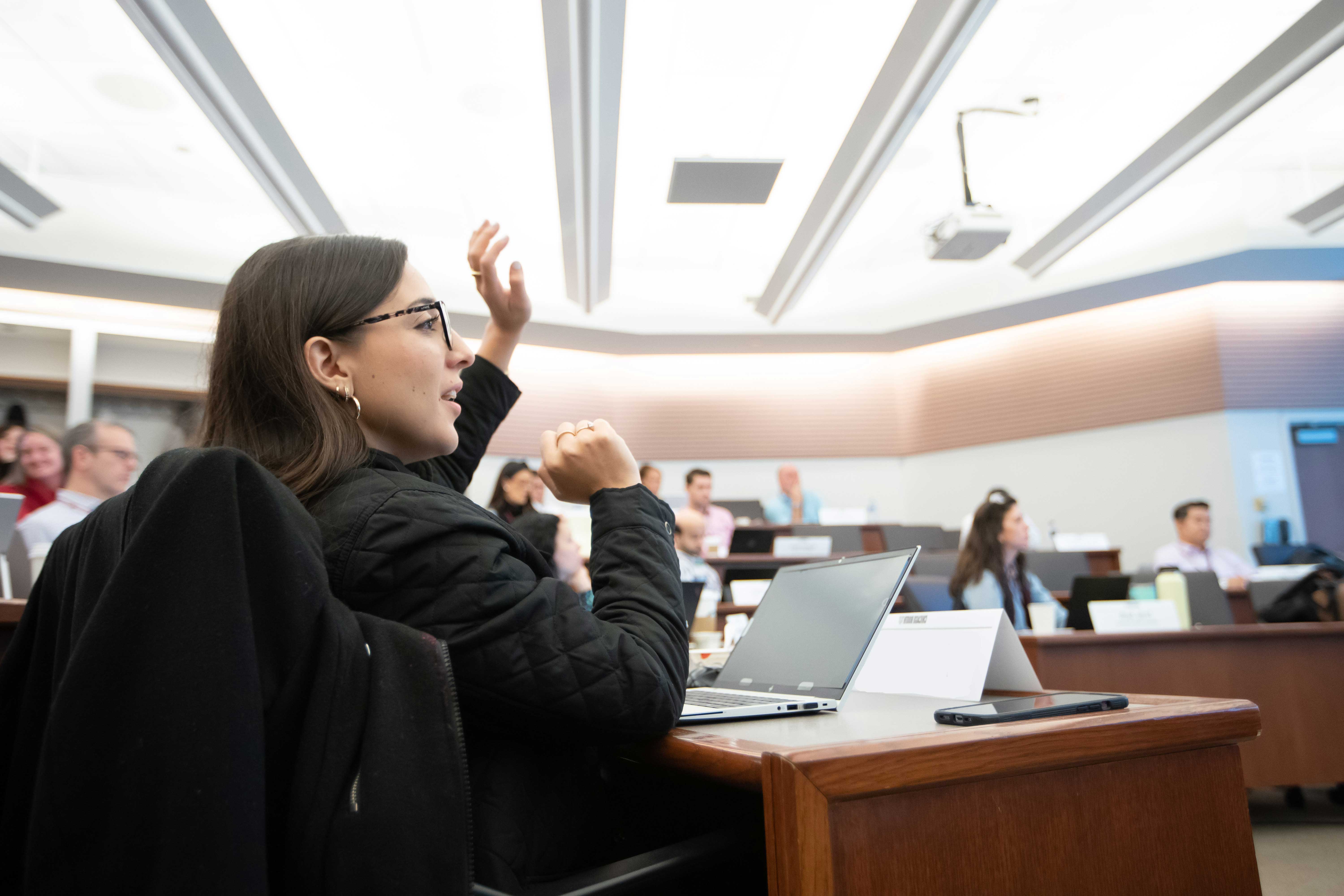 Executive Education student raising her hand in class
