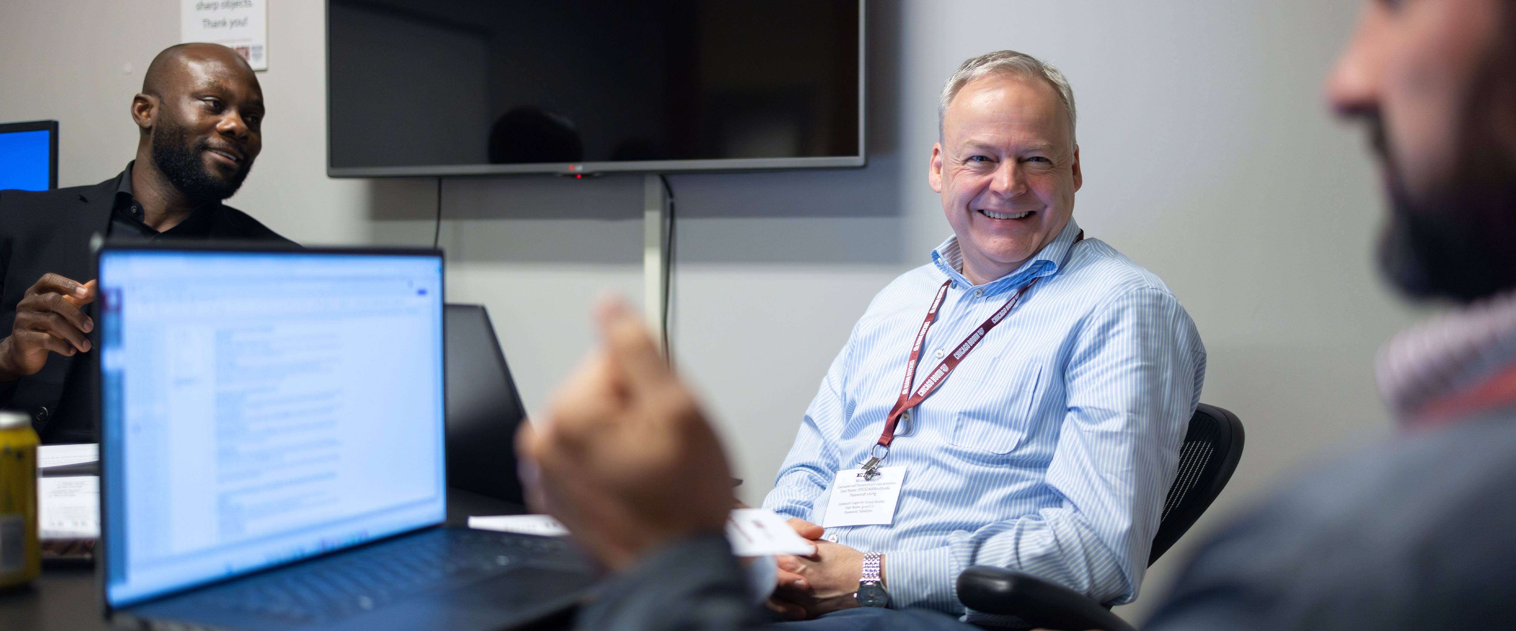 Three students talking discussing in group meeting
