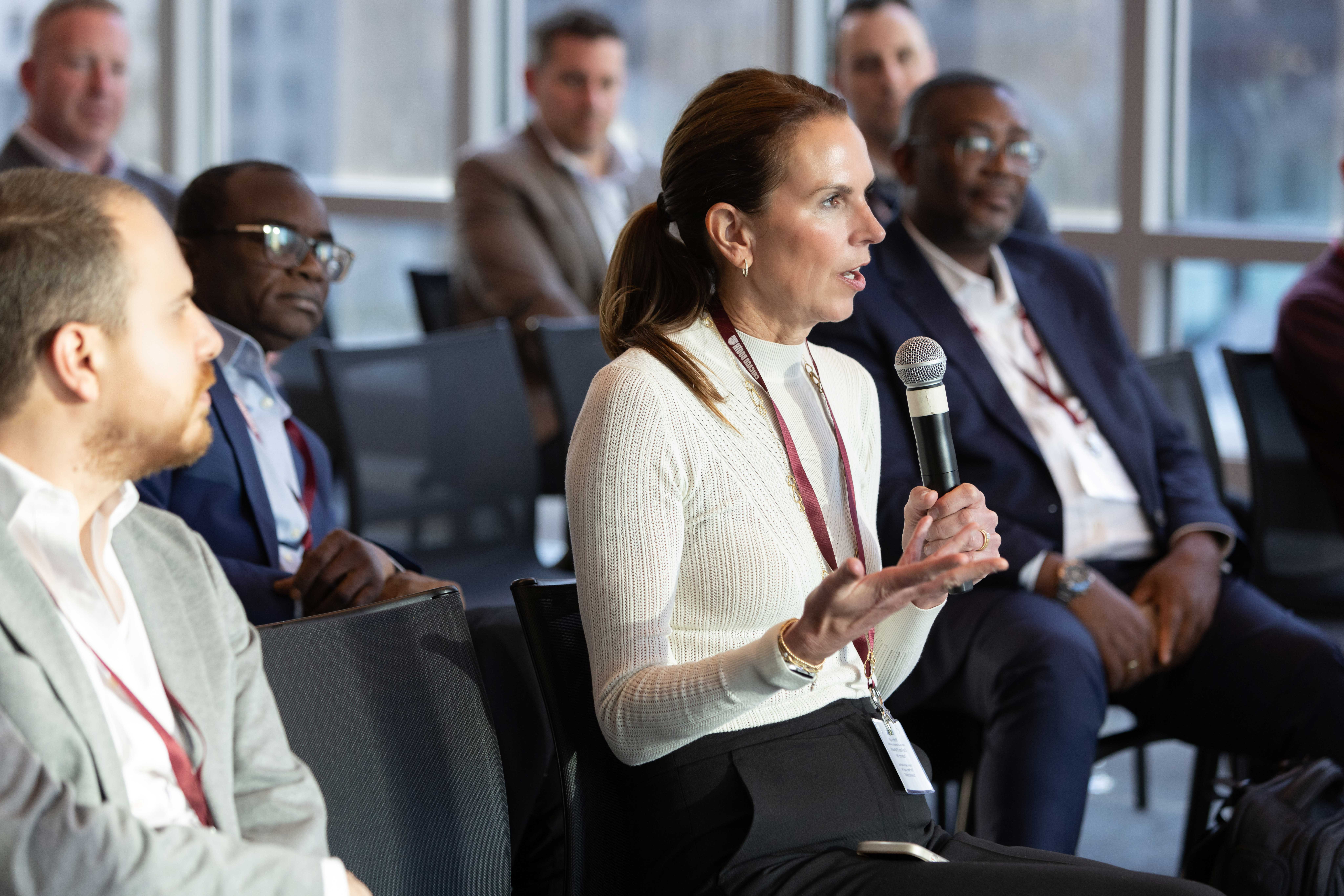 Leadership student in a classroom speaking into a microphone